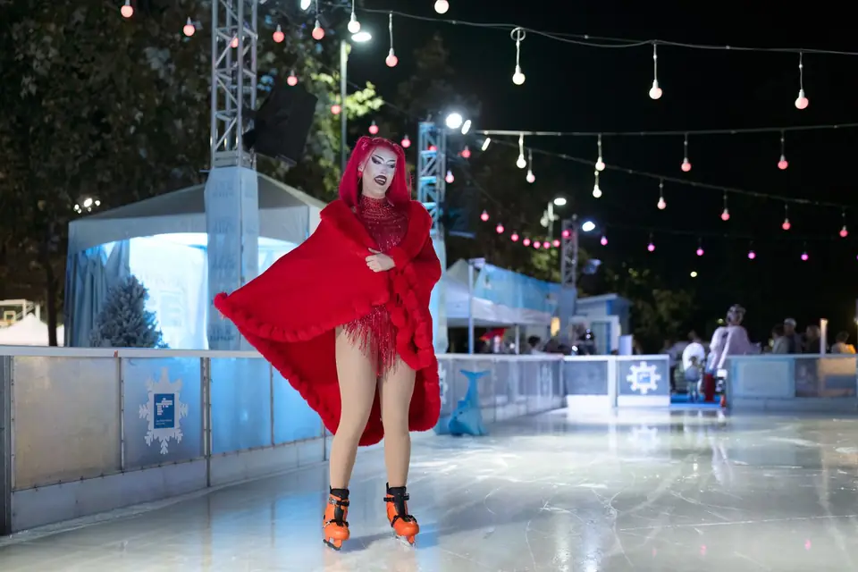 A skater in a flowing red cape